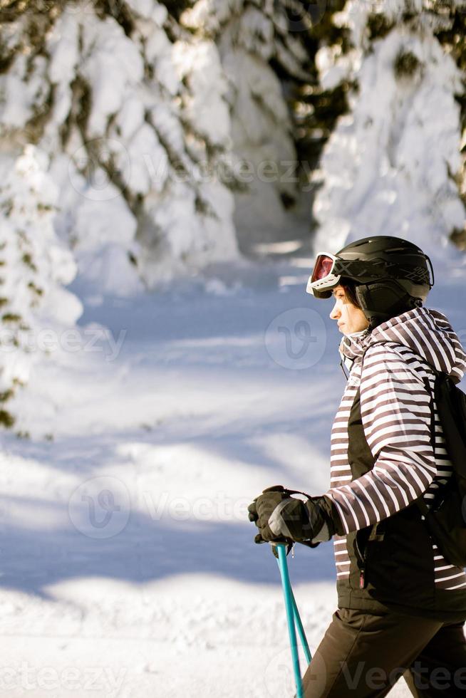 Young woman at winter skiing bliss, a sunny day adventure photo