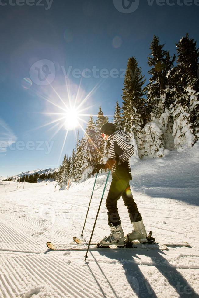 Young woman enjoing winter day of skiing fun in the snow photo