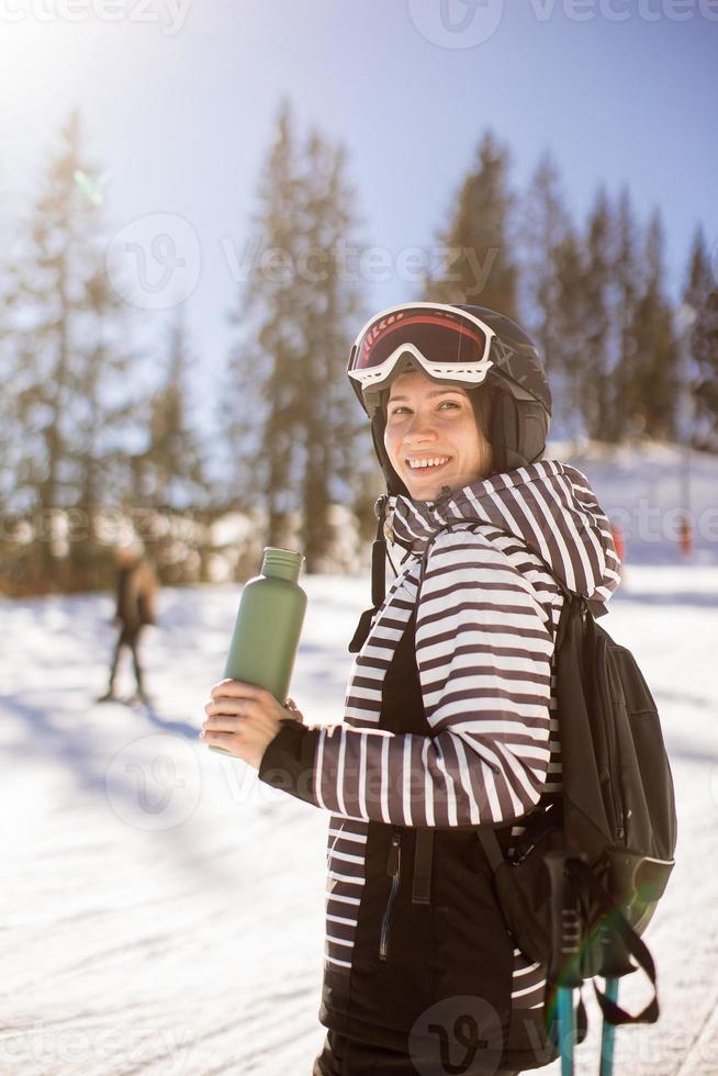 Young woman enjoing winter day of skiing fun in the snow photo