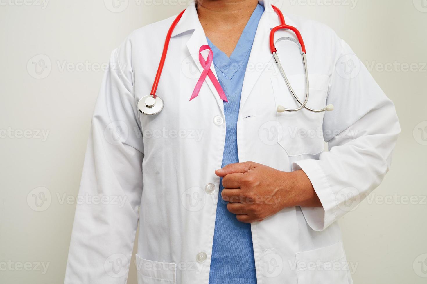 Asian woman doctor with pink ribbon, World Breast Cancer Day at October. photo