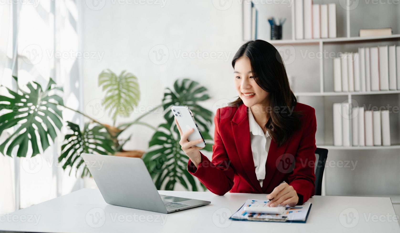 confidente negocio experto atractivo sonriente joven mujer mecanografía ordenador portátil ang participación digital tableta en escritorio en creativo oficina. foto