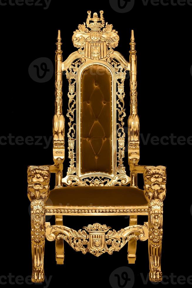 Golden royal chair isolated on black background. A place for the king. Throne. Royal chair. photo