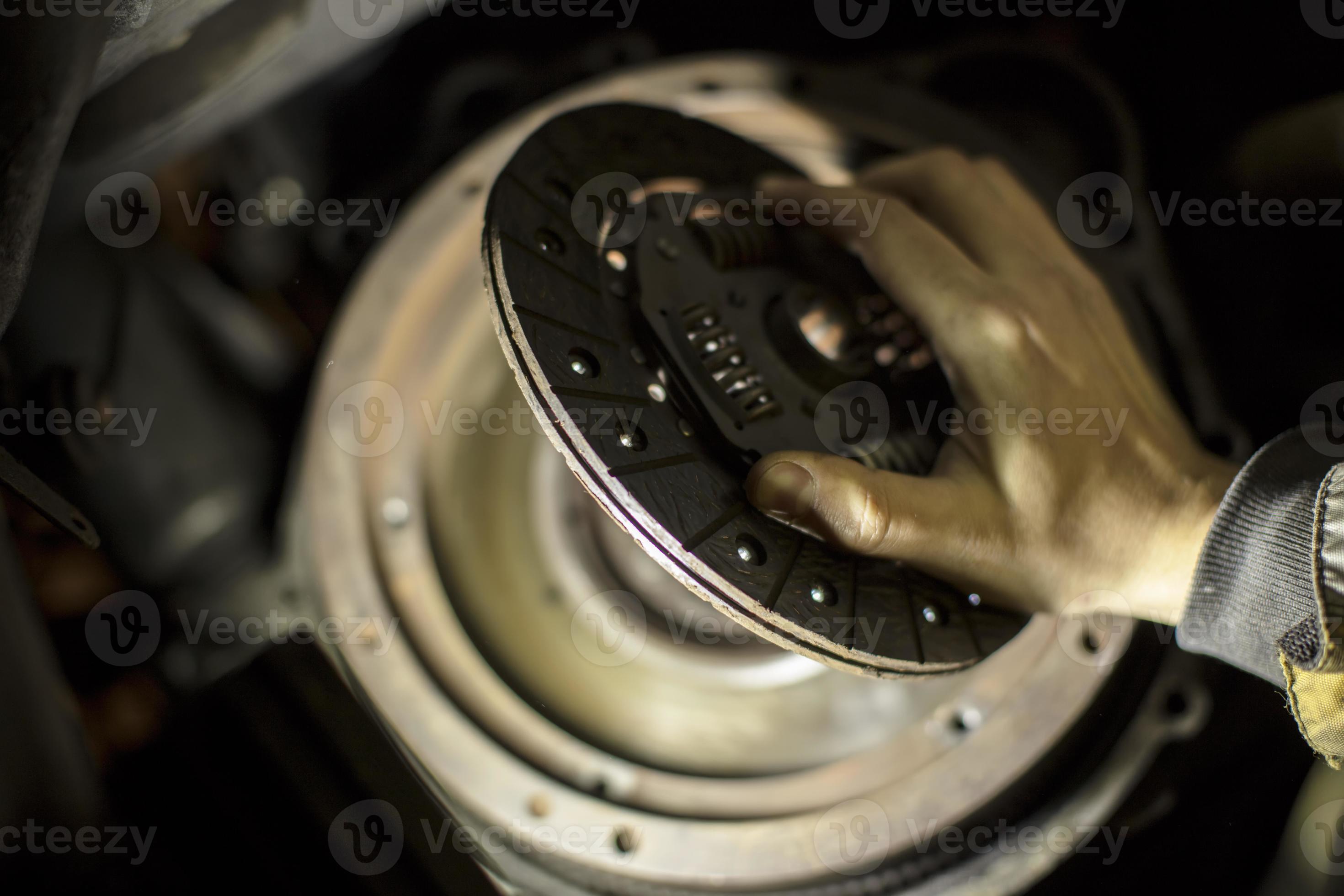 Car engine maintenance. Engine clutch repair. Hands with a mechanic