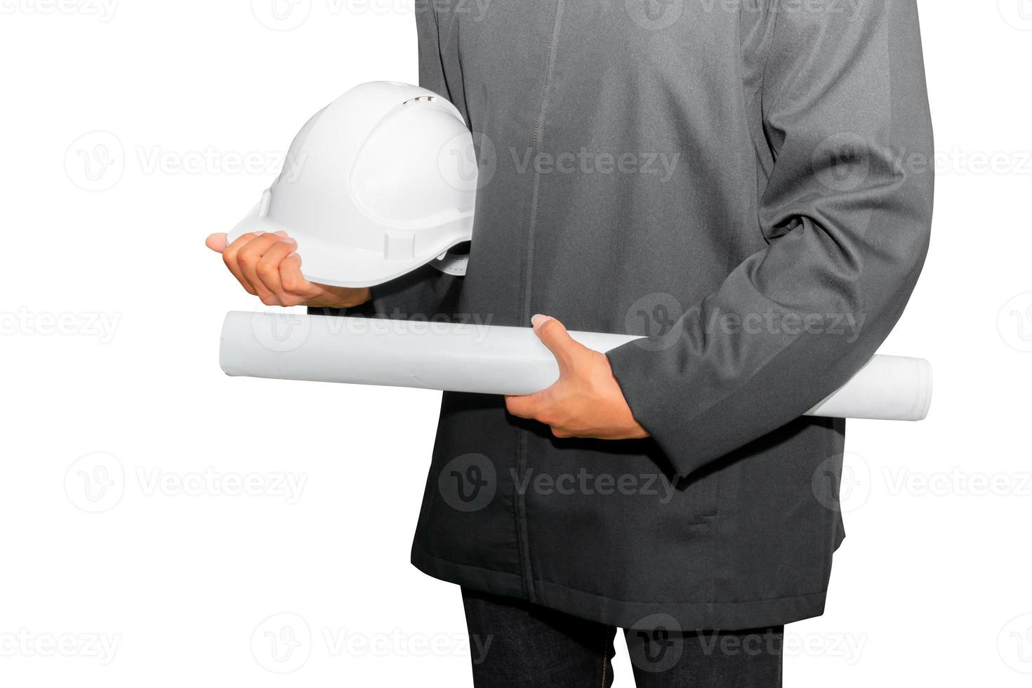 hand of engineering holding paper plan blueprint with white safety helmet plastic in construction isolated on white background and clipping path photo