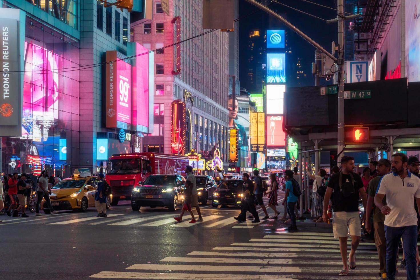 New York City, USA - August 9, 2019-People and tourists stroll among the lights and skyscrapers of Time Square in Manhattan during a summer night photo