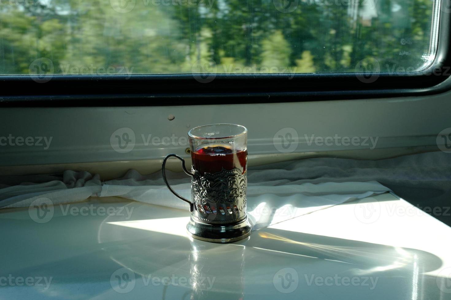 Travel by train in Russia. Tea in the metal cup holder. photo
