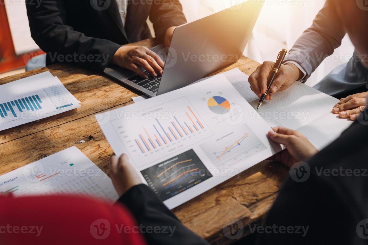 Financial analysts analyze business financial reports on a digital tablet planning investment project during a discussion at a meeting of corporate showing the results of their successful teamwork. photo