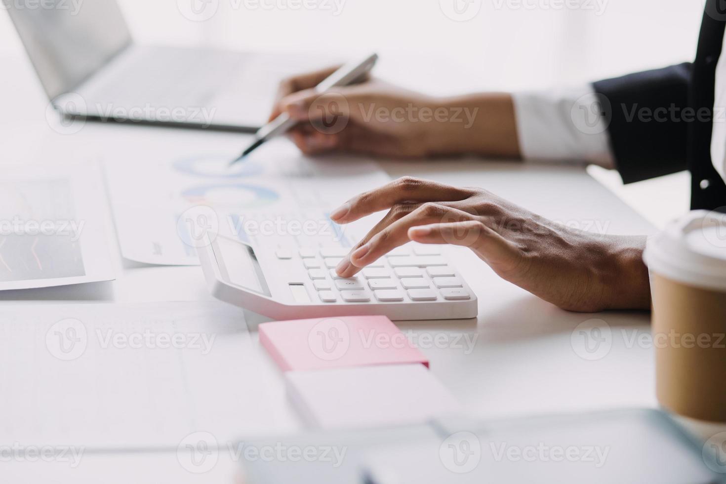 Financial analysts analyze business financial reports on a digital tablet planning investment project during a discussion at a meeting of corporate showing the results of their successful teamwork. photo