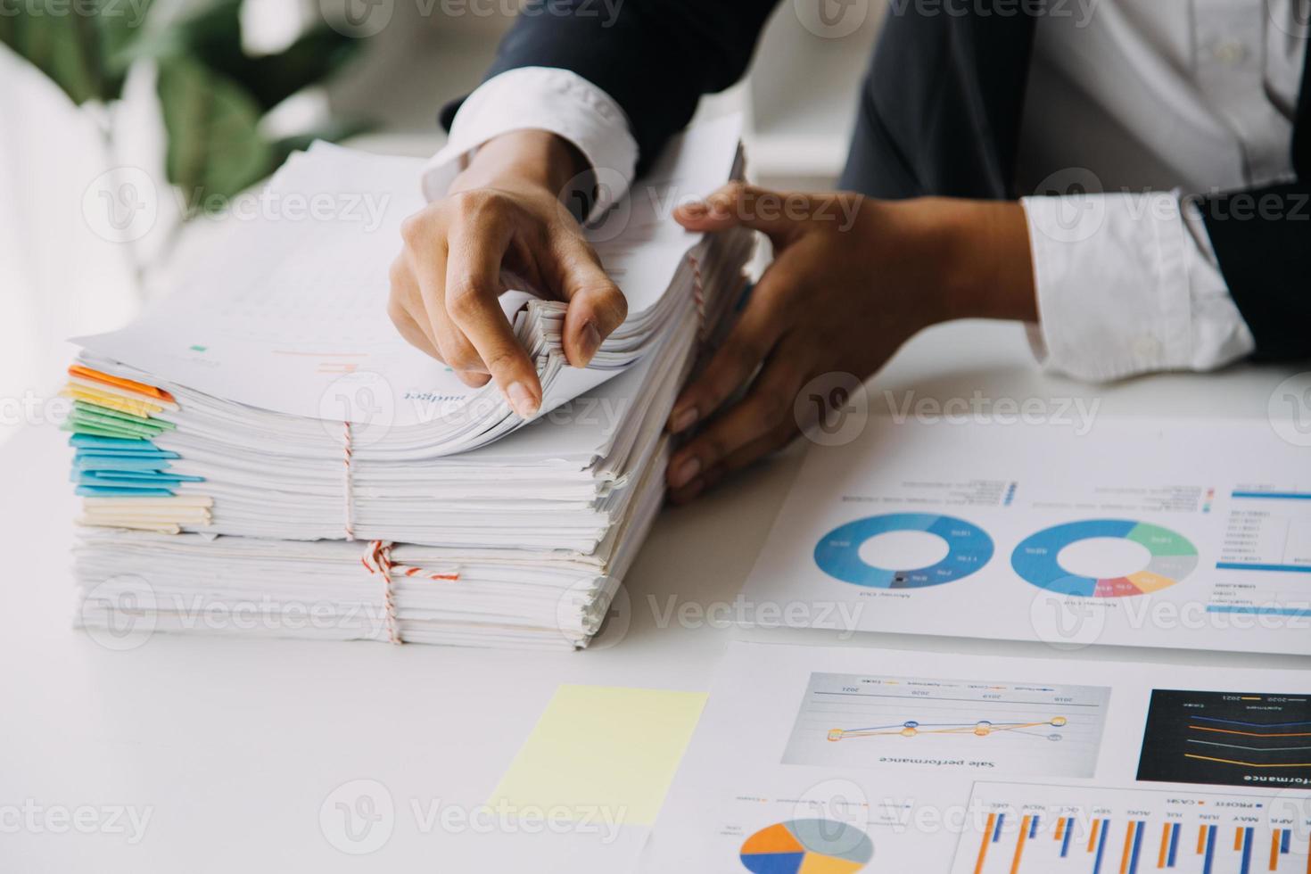 Financial analysts analyze business financial reports on a digital tablet planning investment project during a discussion at a meeting of corporate showing the results of their successful teamwork. photo