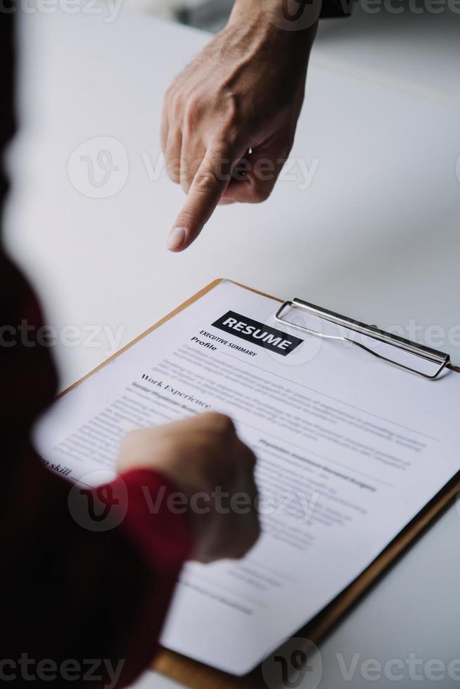 Close up view of job interview in office, focus on resume writing tips, employer reviewing good cv of prepared skilled applicant, recruiter considering application, hr manager making hiring decision photo