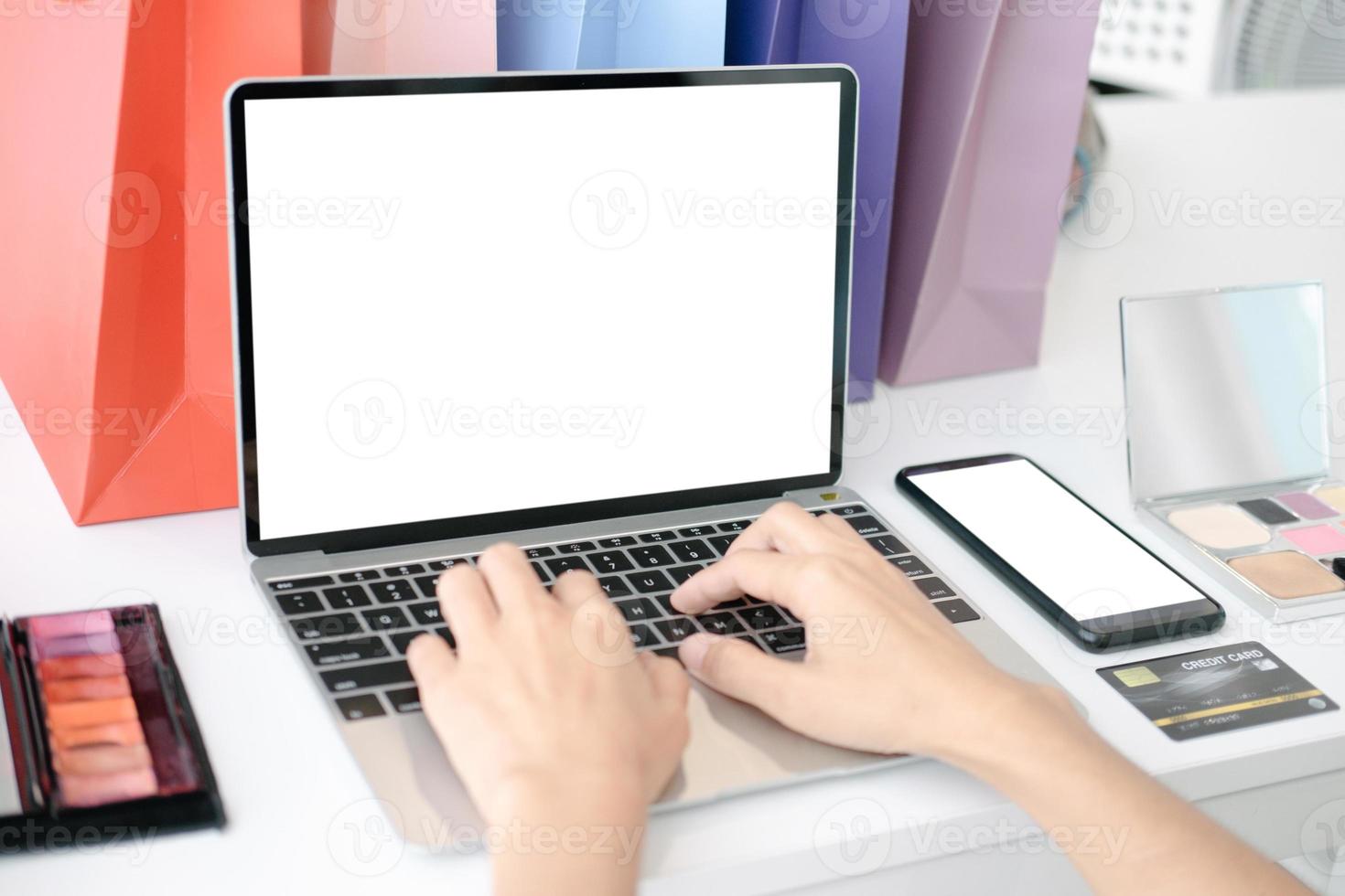 Mockup image of Beautiful woman shopping online with laptop and smartphone on online websites, mockup concept photo