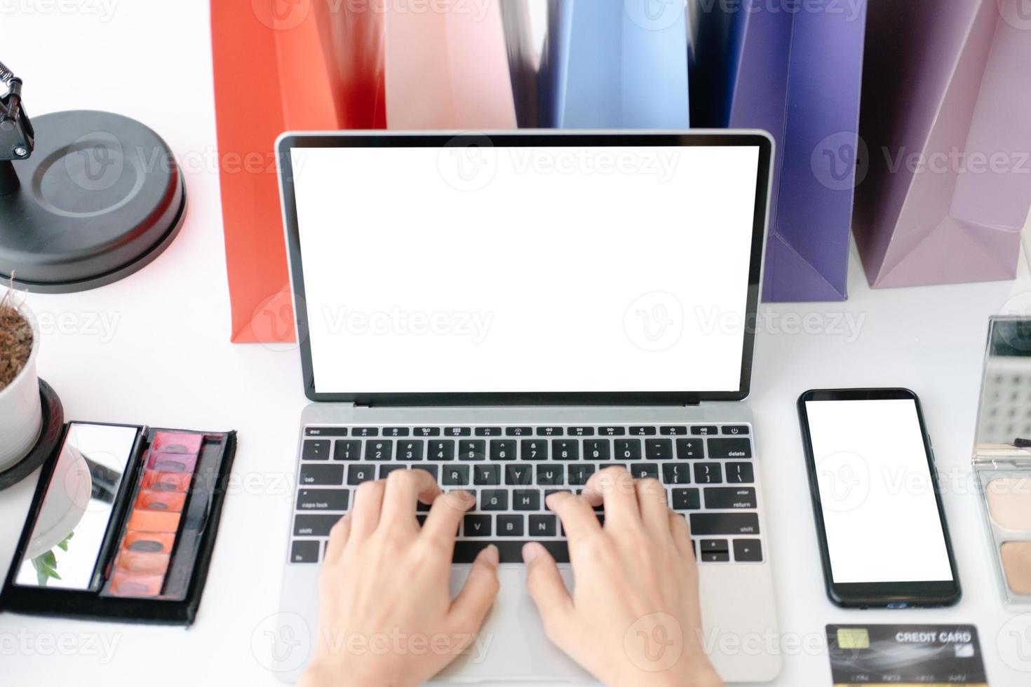 Mockup image of Beautiful woman shopping online with laptop and smartphone on online websites, mockup concept photo