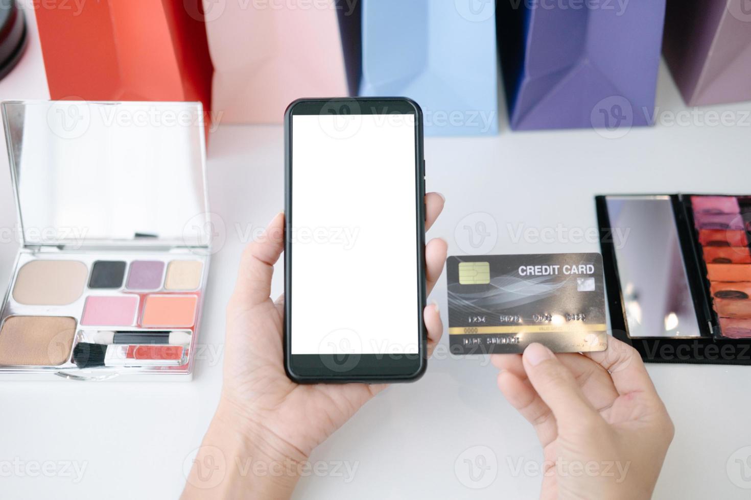 Mockup image of Beautiful woman holding credit card shopping online with smartphone on online websites, mockup concept photo