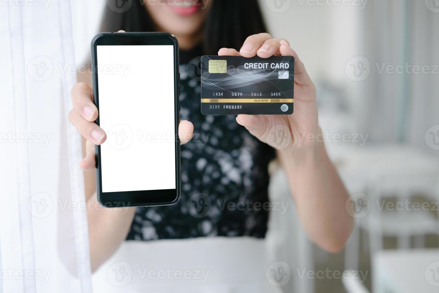 Mockup image of Beautiful woman holding credit card shopping online with smartphone on online websites, mockup concept photo