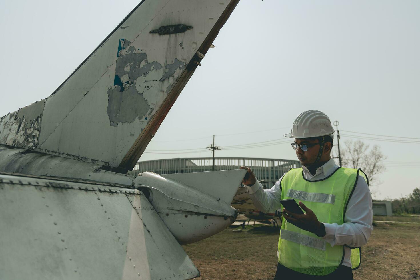 Aircraft mechanic examining airplane wing photo