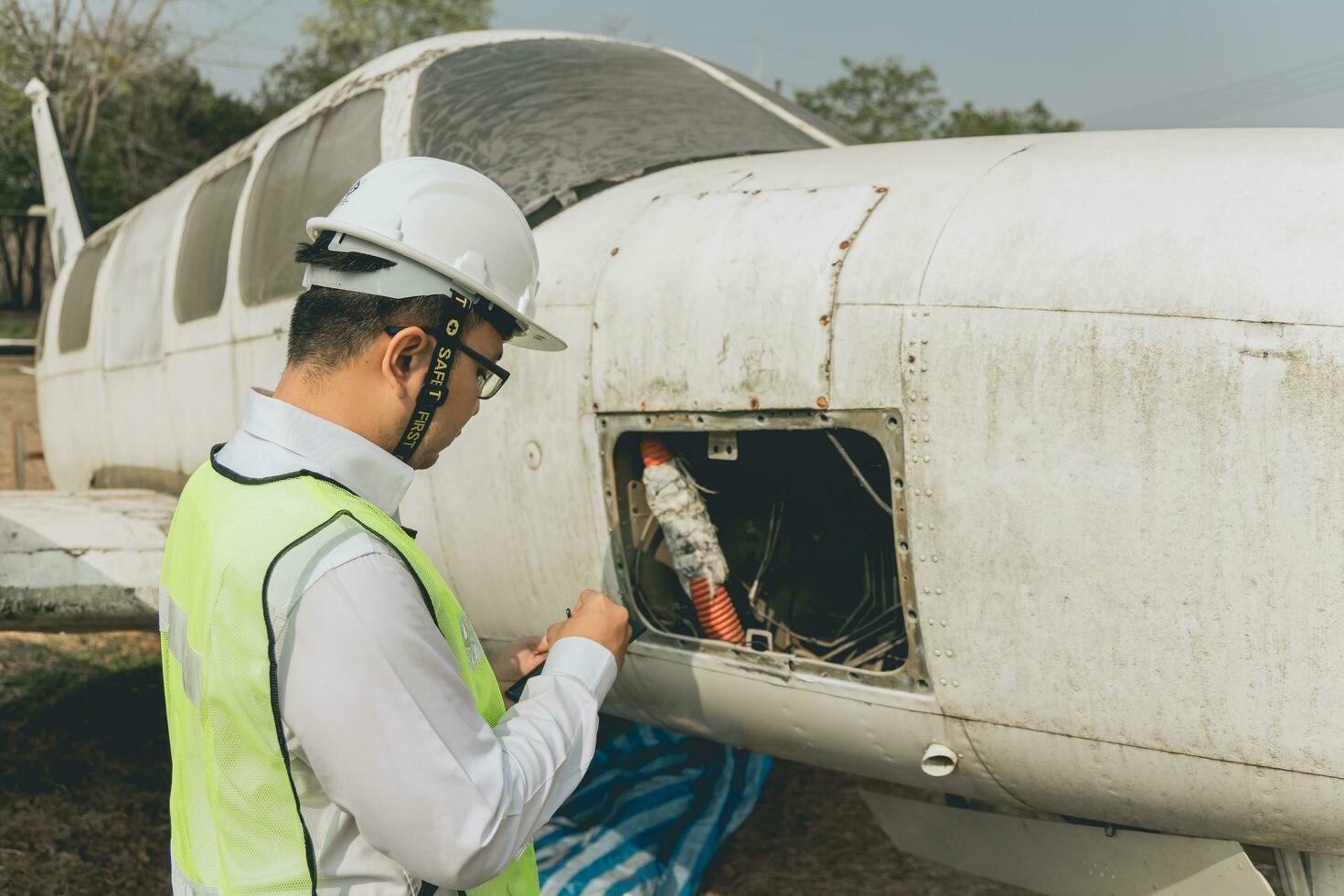 Engineer maintaining a helicopter Engine. Male engine machanic helicopter checking helicopter before take off photo