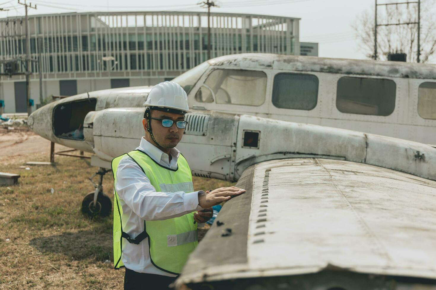 Aircraft mechanic examining airplane wing photo