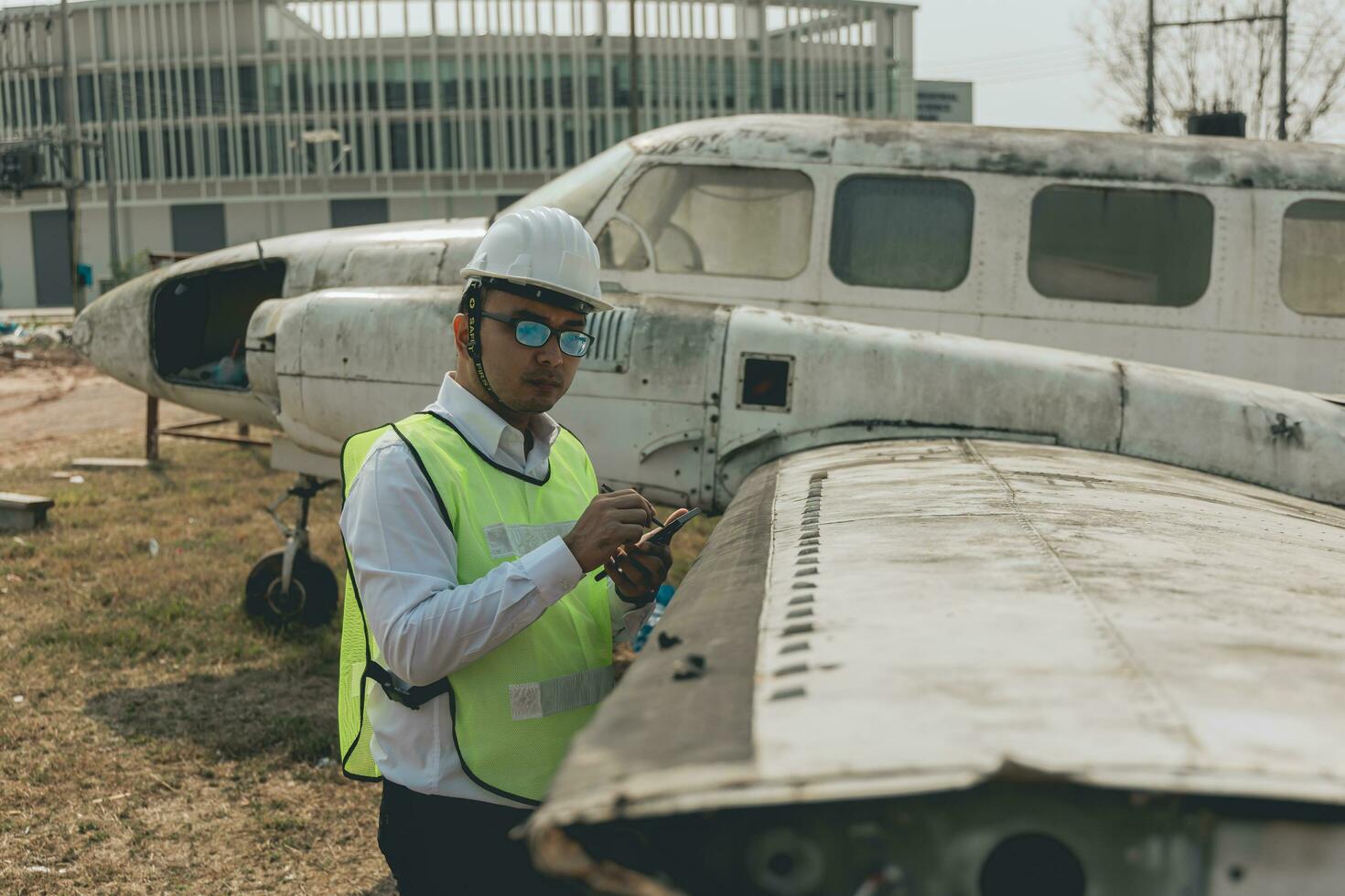 Aircraft mechanic examining airplane wing photo