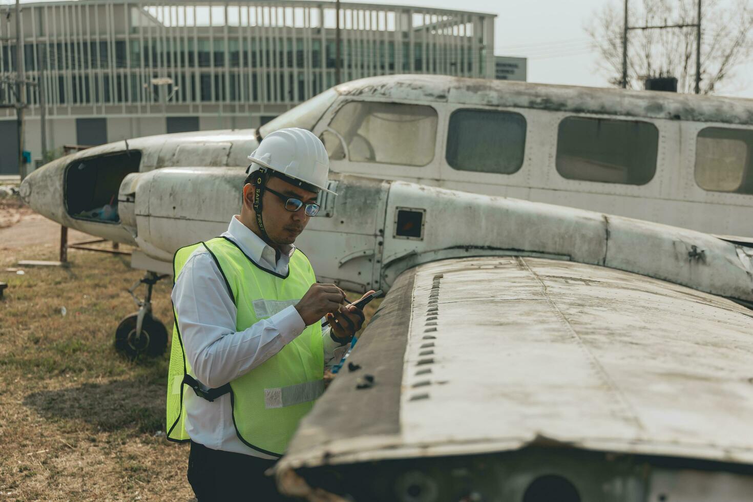 Aircraft mechanic examining airplane wing photo