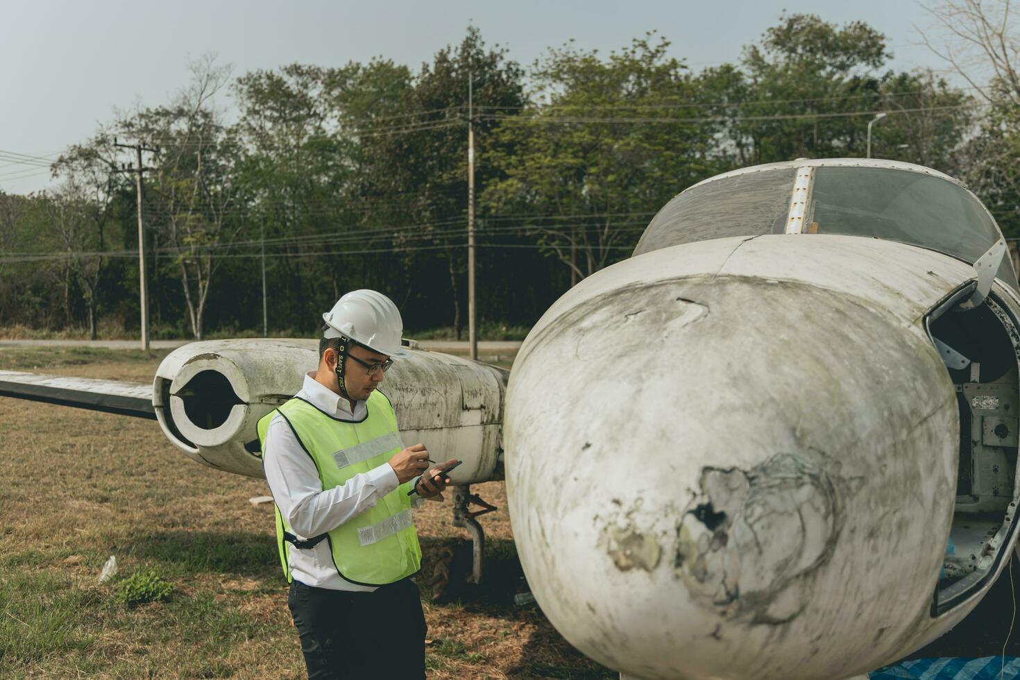 Aircraft mechanic examining airplane wing photo