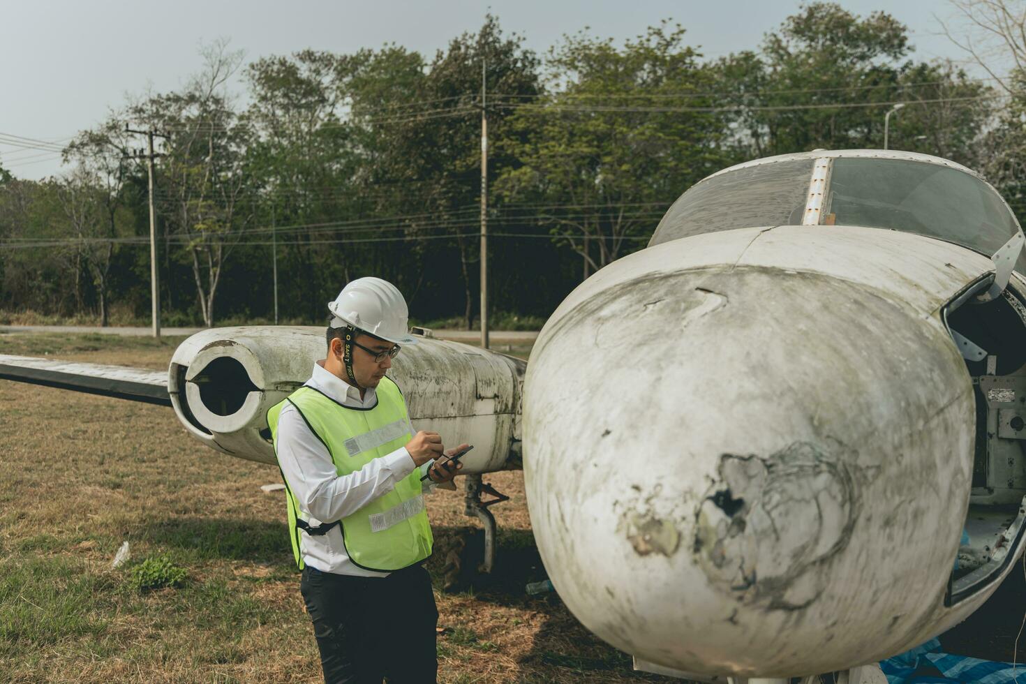 Aircraft mechanic examining airplane wing photo