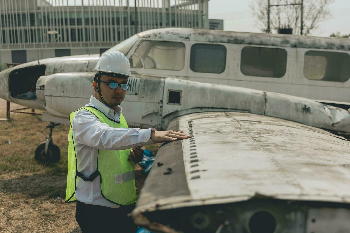 Aircraft mechanic examining airplane wing photo