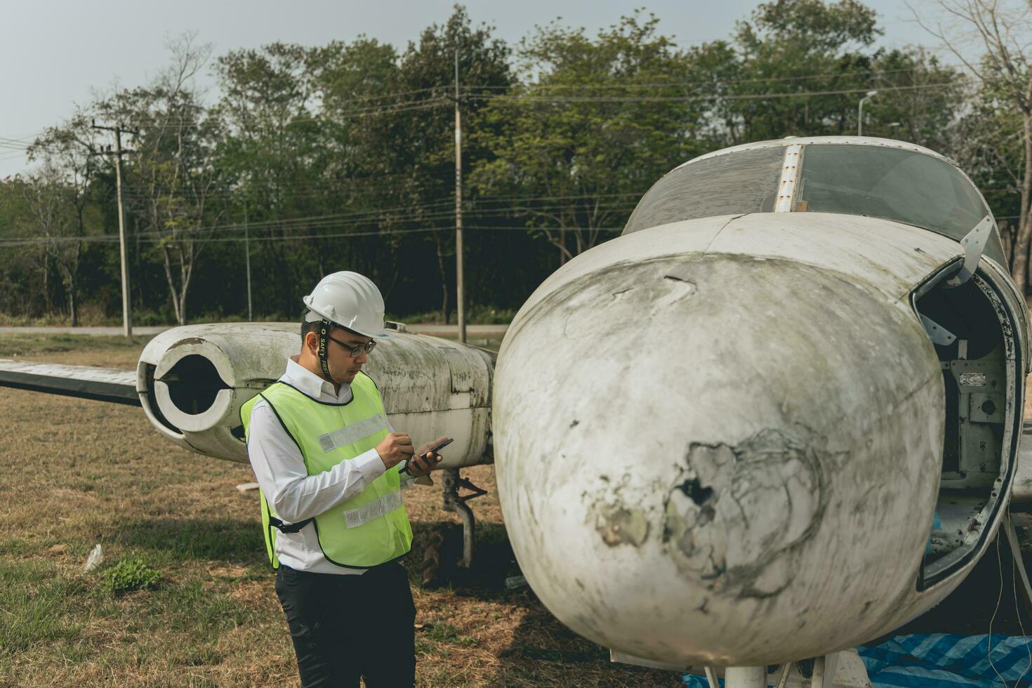 Aircraft mechanic examining airplane wing photo