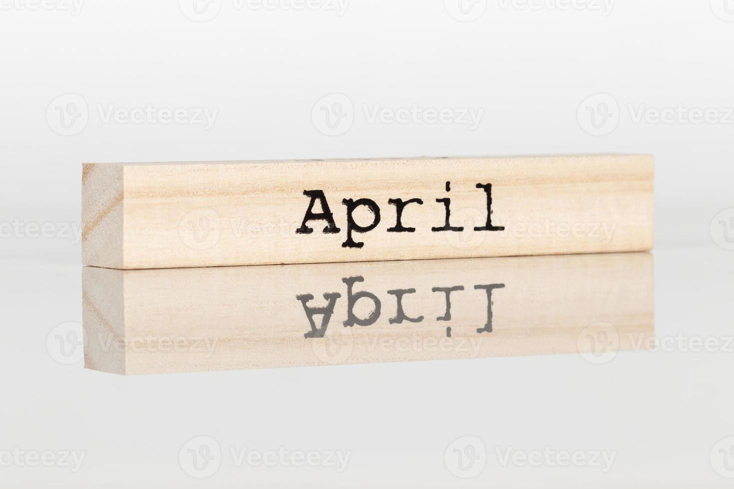 wooden cube with an inscription April on a white background photo