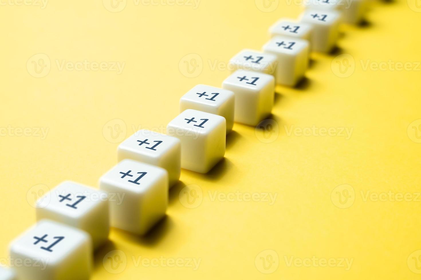 Sequential chain of blocks with plus one. Sequence. Arithmetic progression. Add one more. Increase and growth. A series concept. Accumulation process. Continuation. Sequential addition to the sum. photo