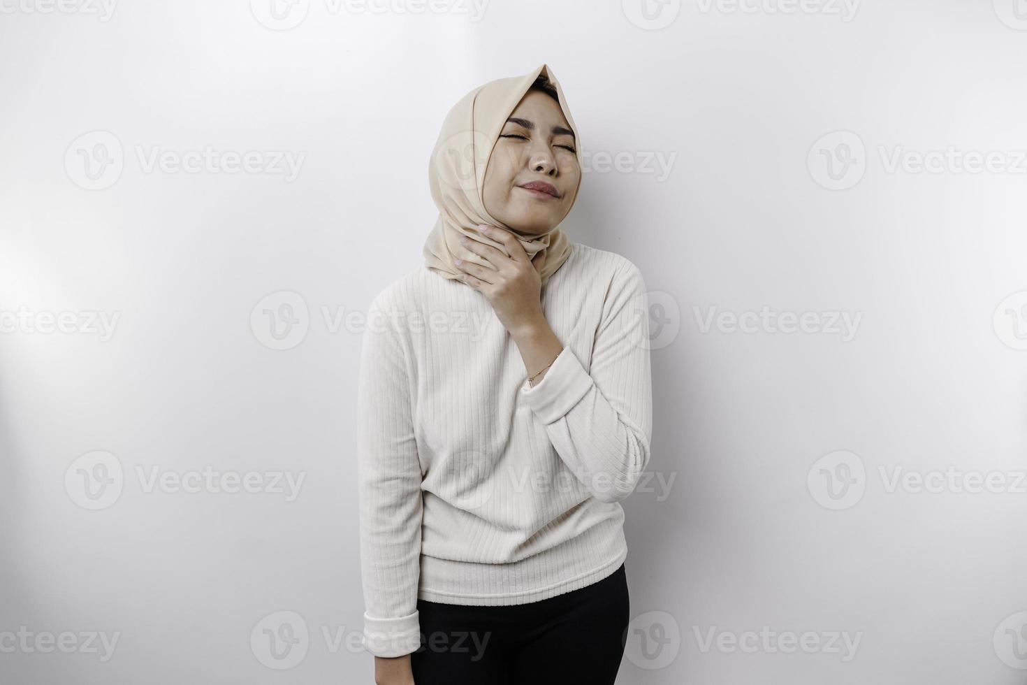 An Asian Muslim woman feels so thirsty because of the hot weather during the summer season while fasting photo