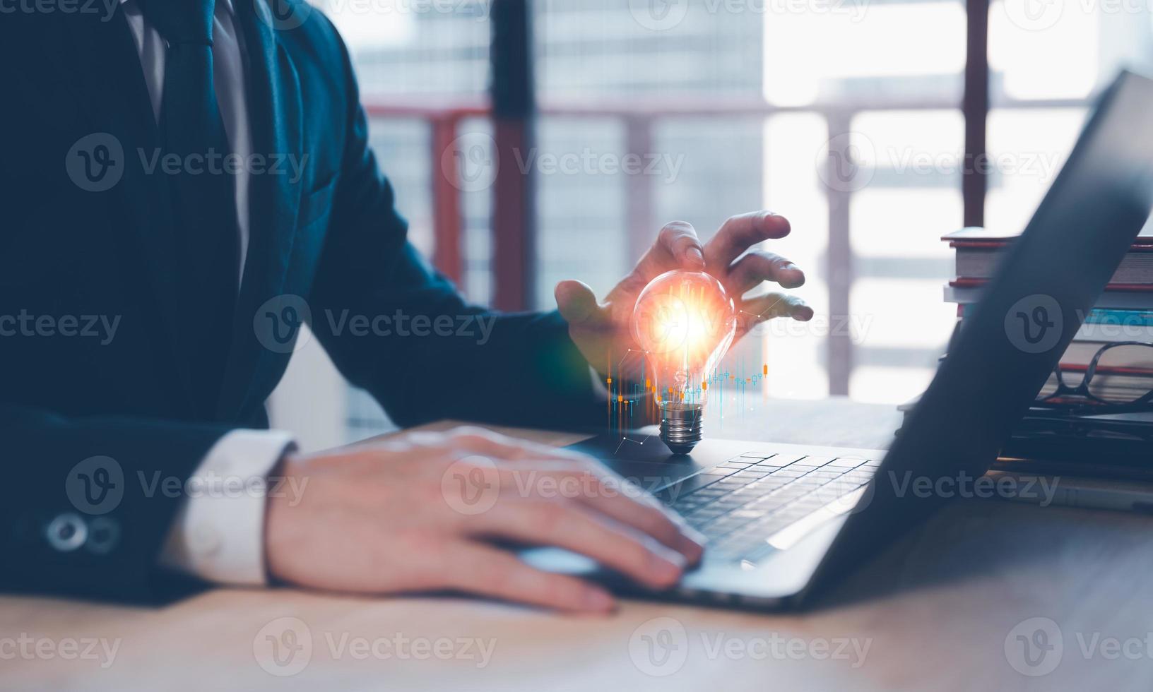 ideas inspiration concept, businessman with illuminated light bulb, working on laptop at office, concept for idea, innovation and inspiration in business, business opportunities photo
