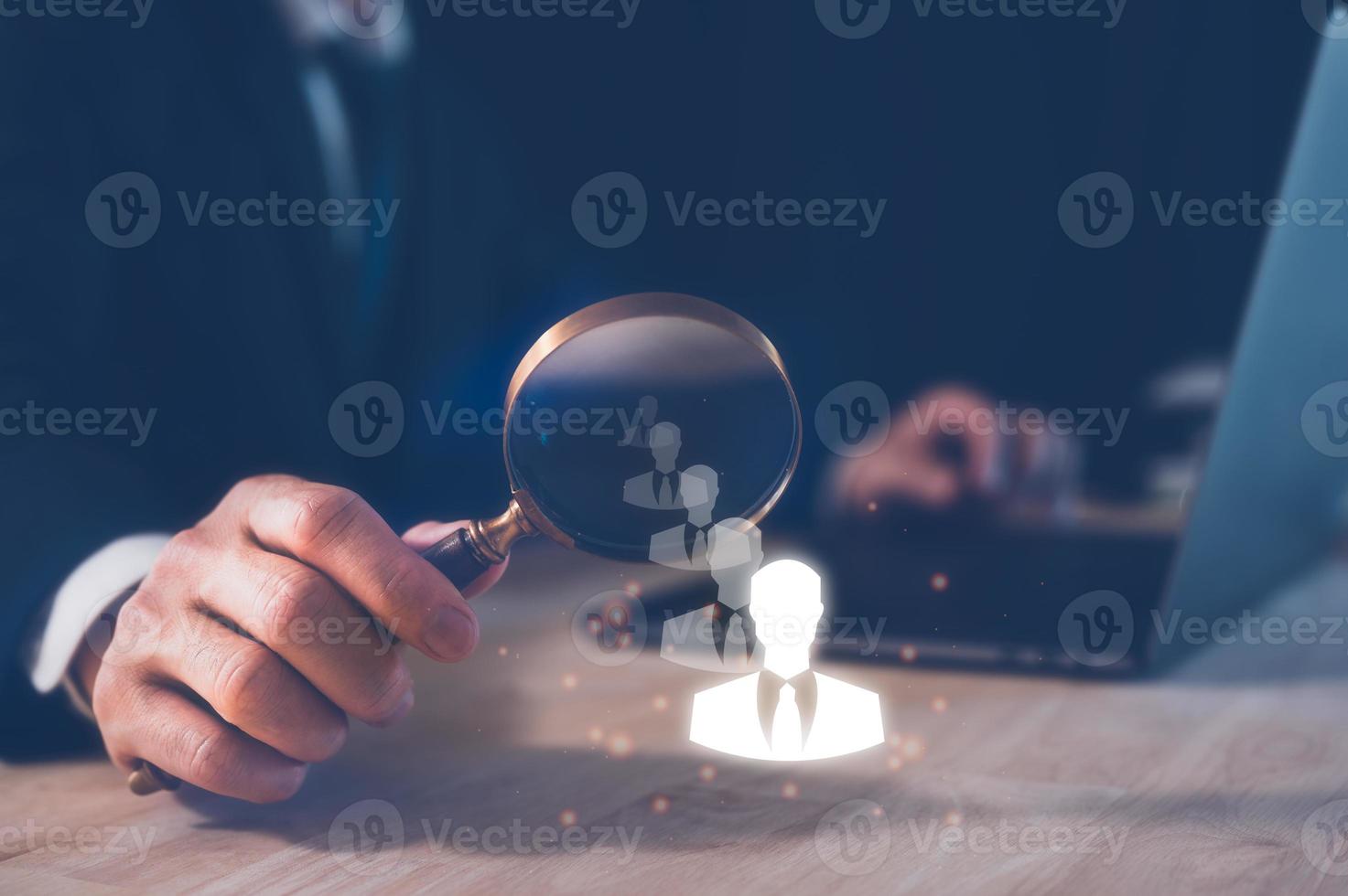 teamwork team leader HRM or Human Resource Management, businessman holding magnifying glass with icon in concept of human development team recruitment leadership and customer target group concept. photo