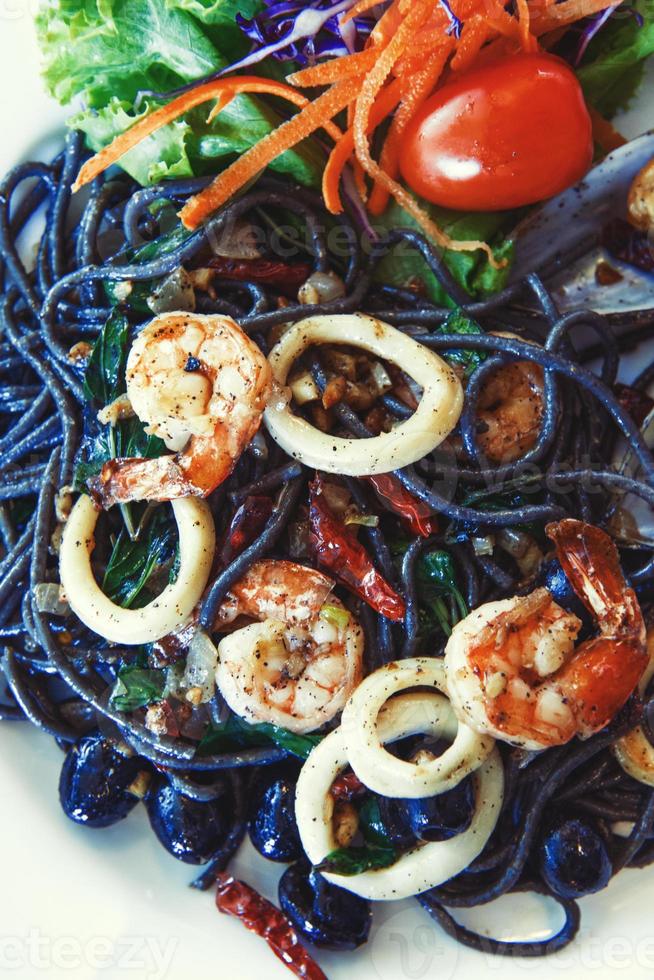 Black spaghetti with seafood photo