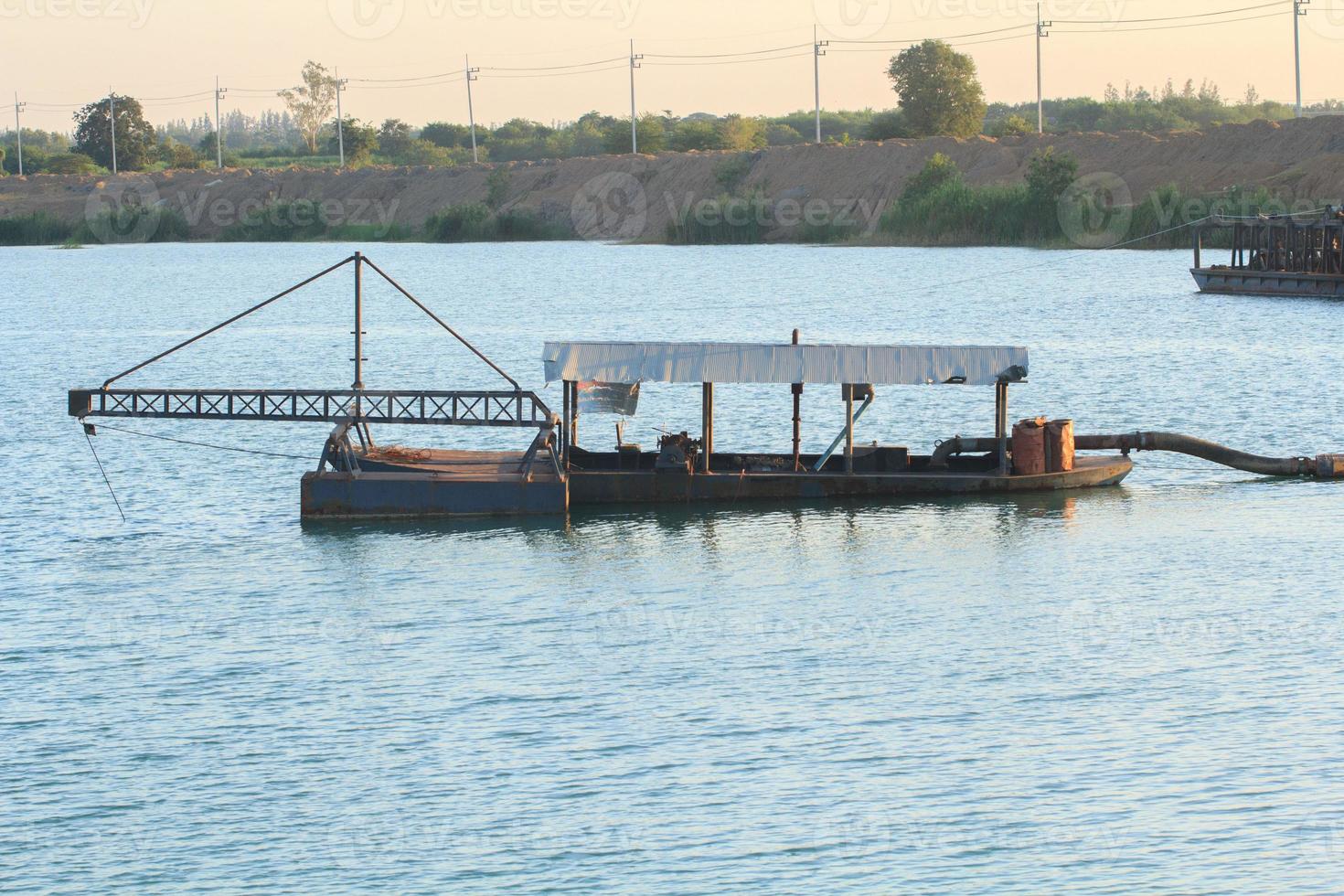 Sand suction vessels are transporting sand from steel pipes in deep rivers for the construction of industries such as houses, buildings, roads and many others where sand is used as a mixture. photo