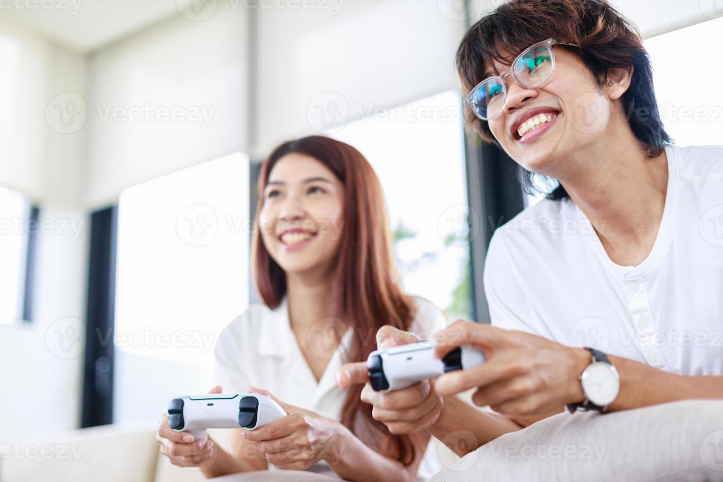 Fun at Home, Couple Playing Video Games Together on Couch photo