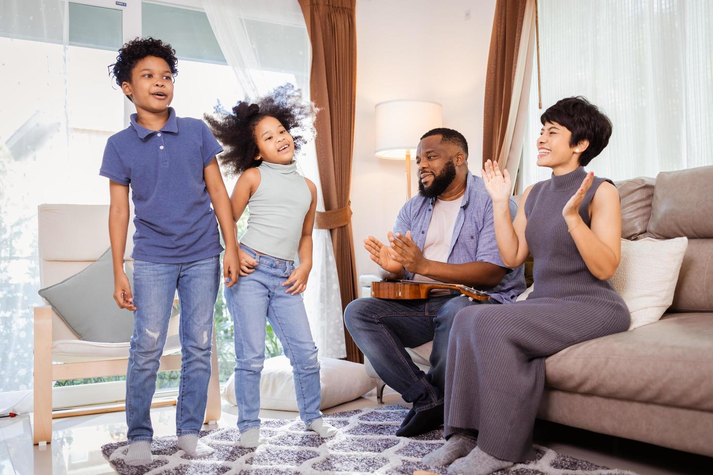 Smiling Family with Kids Dancing at Home, Great for Family Blogs and Magazines photo