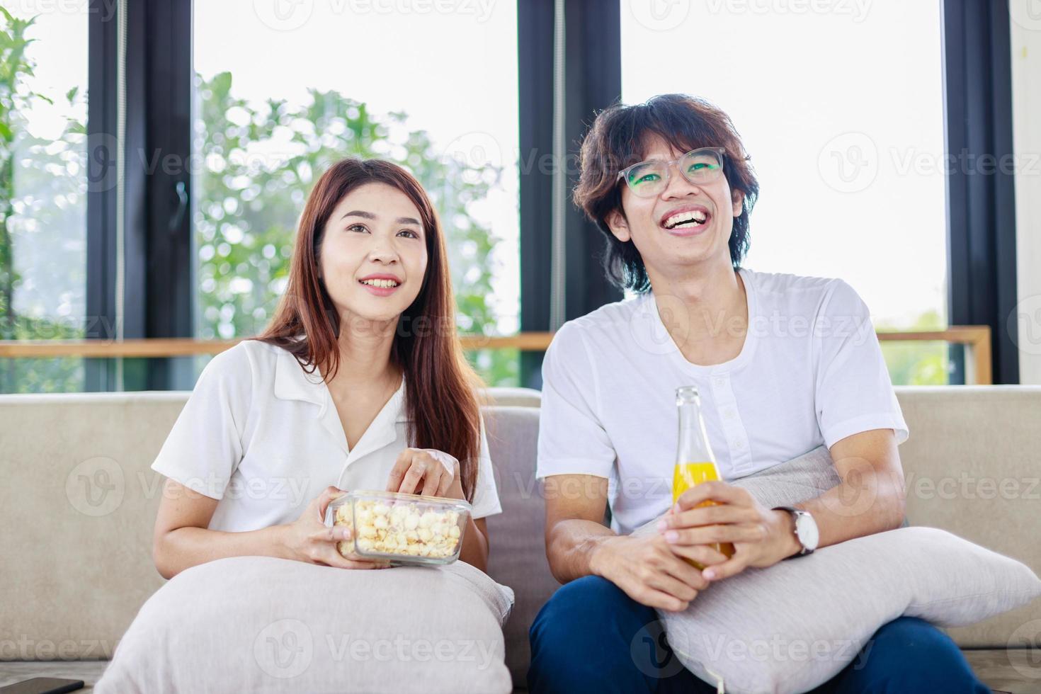 Romantic Evening, Couple Snuggling on Couch and Watching Movie Together photo