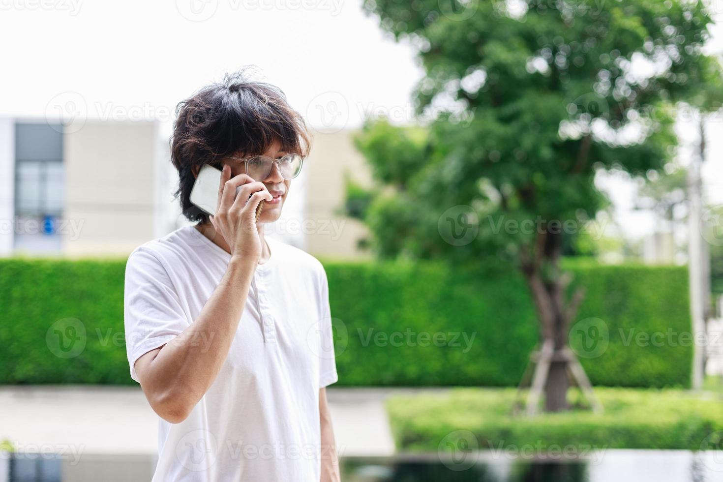 Technology on Vacation, Man Uses Smartphone to Work Remotely by the Pool in Resort Hotel photo