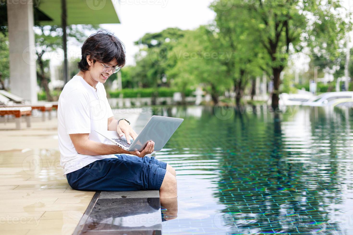 Casual Business Attire and Remote Work for Entrepreneur by the Swimming Pool on Holiday photo