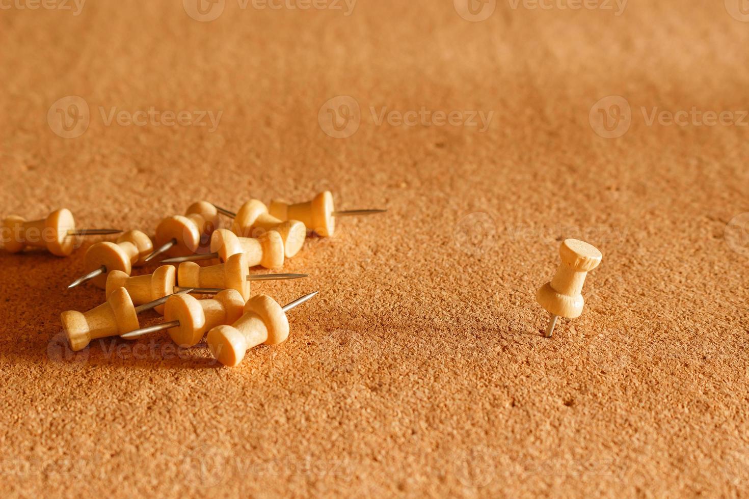 Lots of pins piled up on the cork board photo
