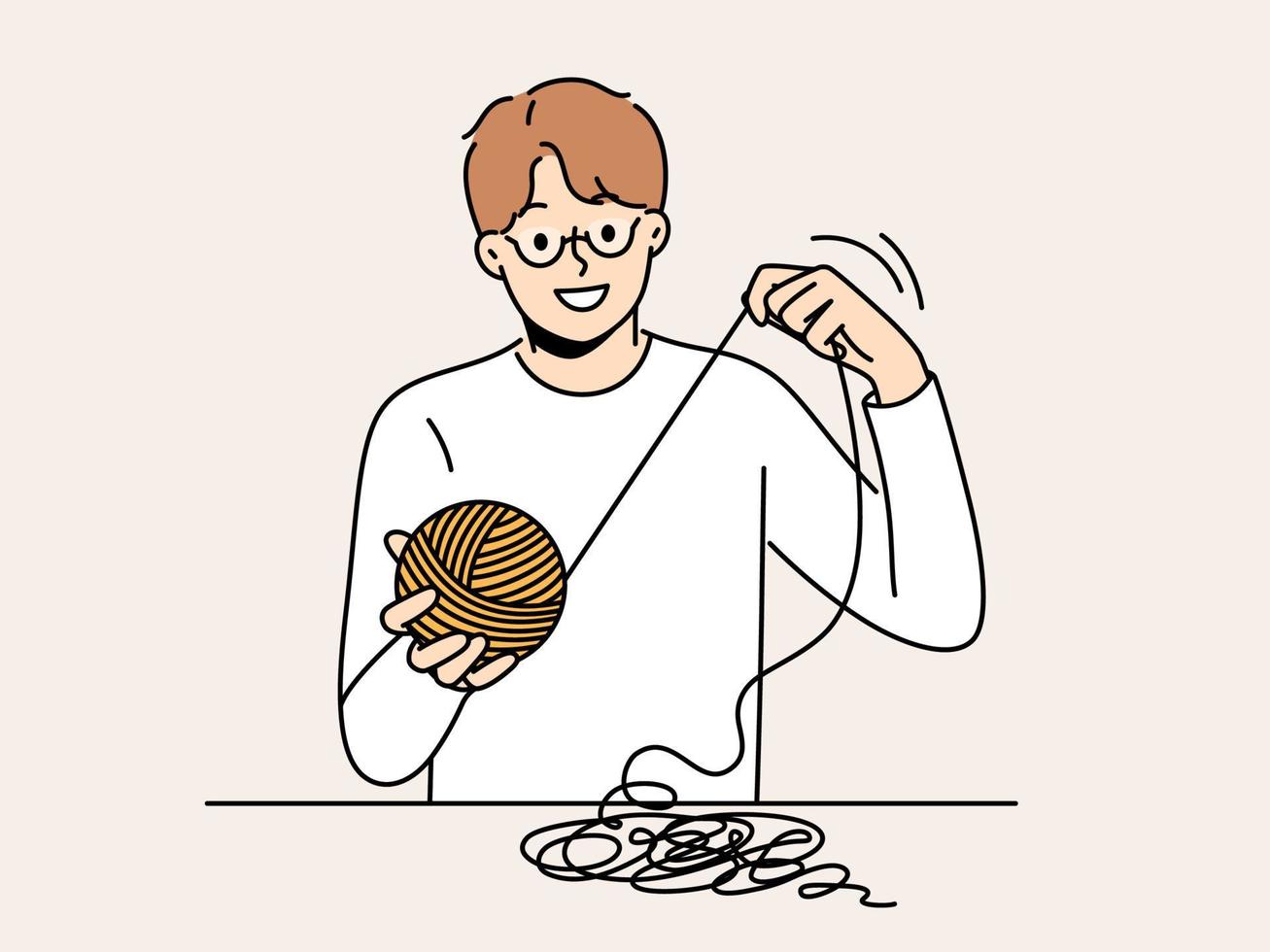 Smiling man sit at table with thread in hands. Happy male in glasses weaving or yarning. Hobby and leisure activity. Vector illustration.