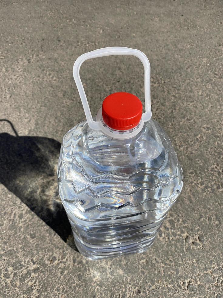 bottle of water standing on road photo