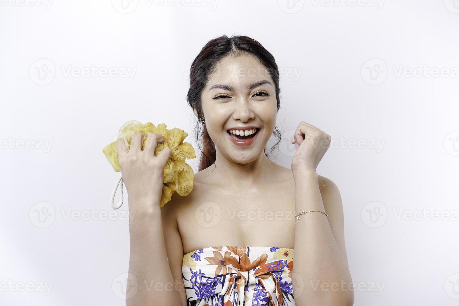 Portrait of happy Asian girl taking shower with gel. She washing with puff, body care beauty concept. photo