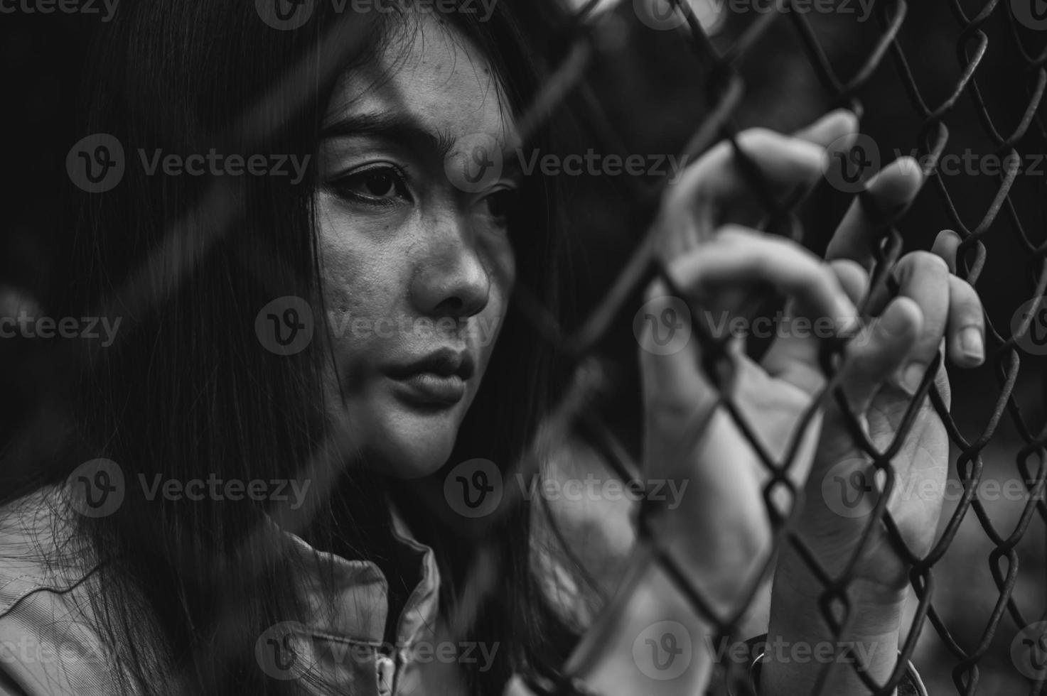Portrait of women desperate to catch the iron prison,prisoner concept,thailand people,Hope to be free,If the violate the law would be arrested and jailed. photo