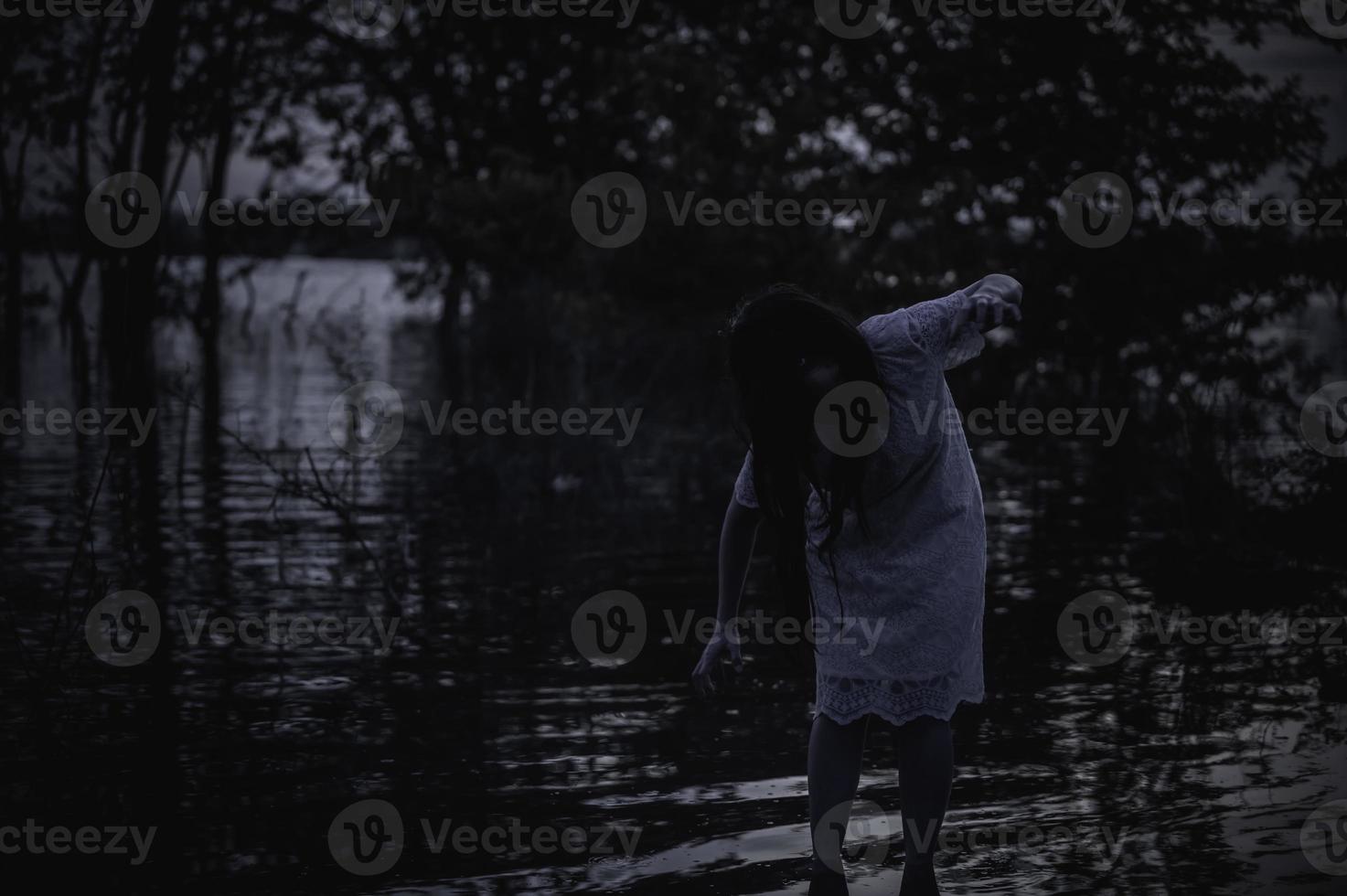 Portrait of asian woman make up ghost face at the swamp,Horror in water scene,Scary at river,Halloween poster,Thailand people photo