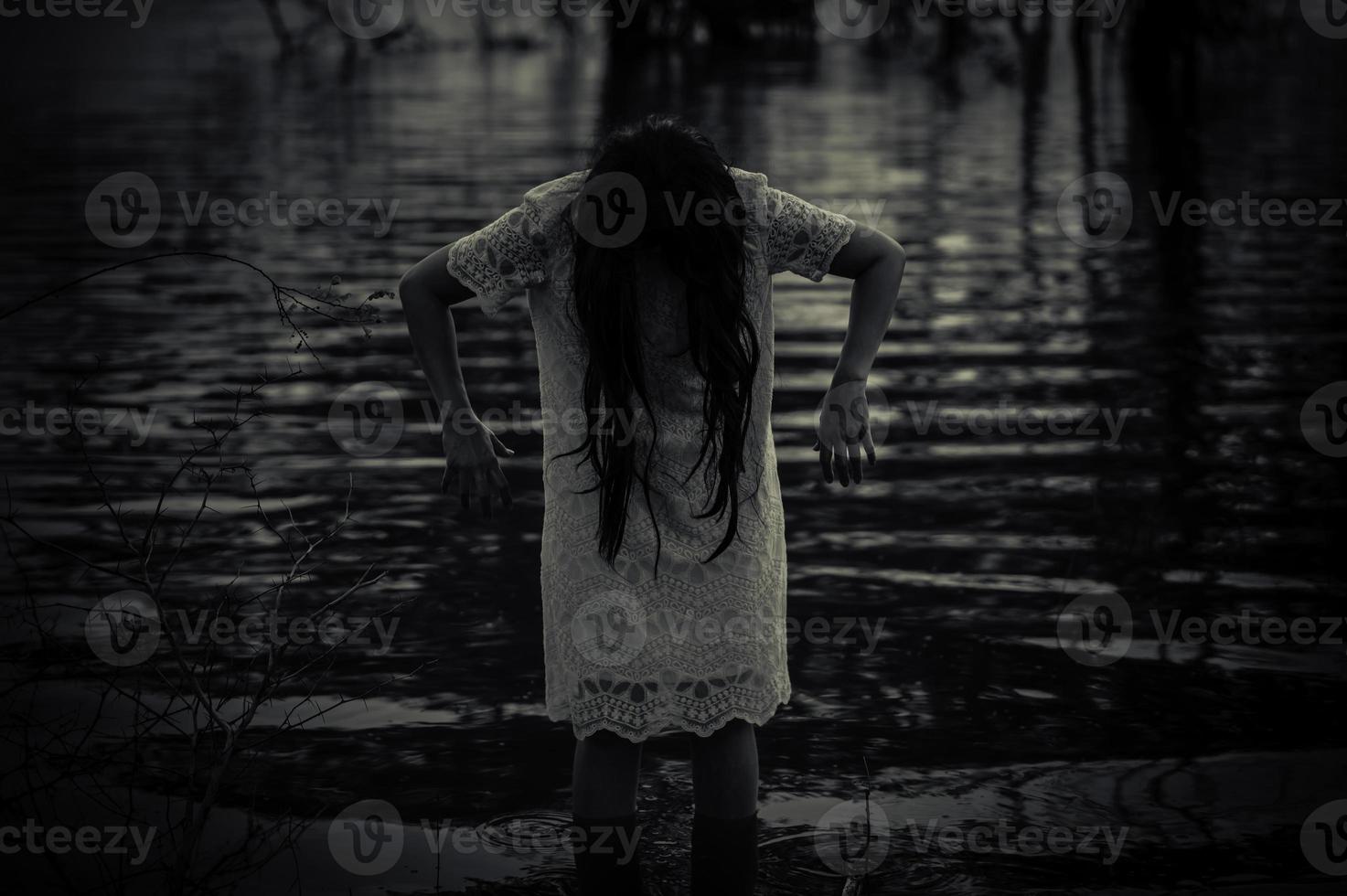 Portrait of asian woman make up ghost face at the swamp,Horror in water scene,Scary at river,Halloween poster,Thailand people photo