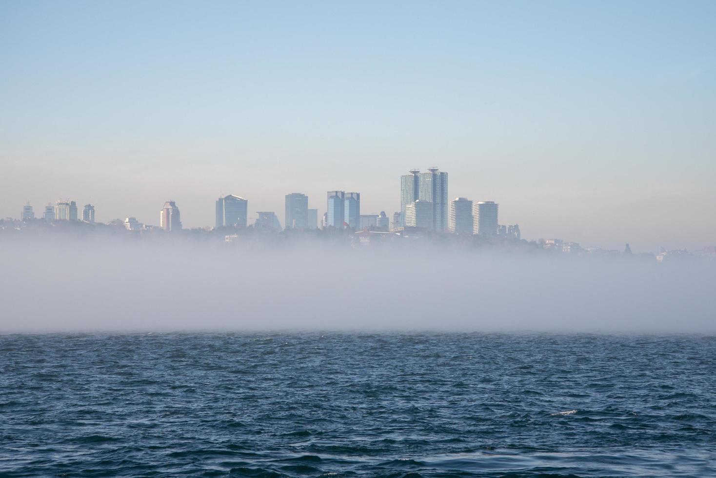 Fog over the Bosphorus Strait, the backdrop to high-rise buildings. photo