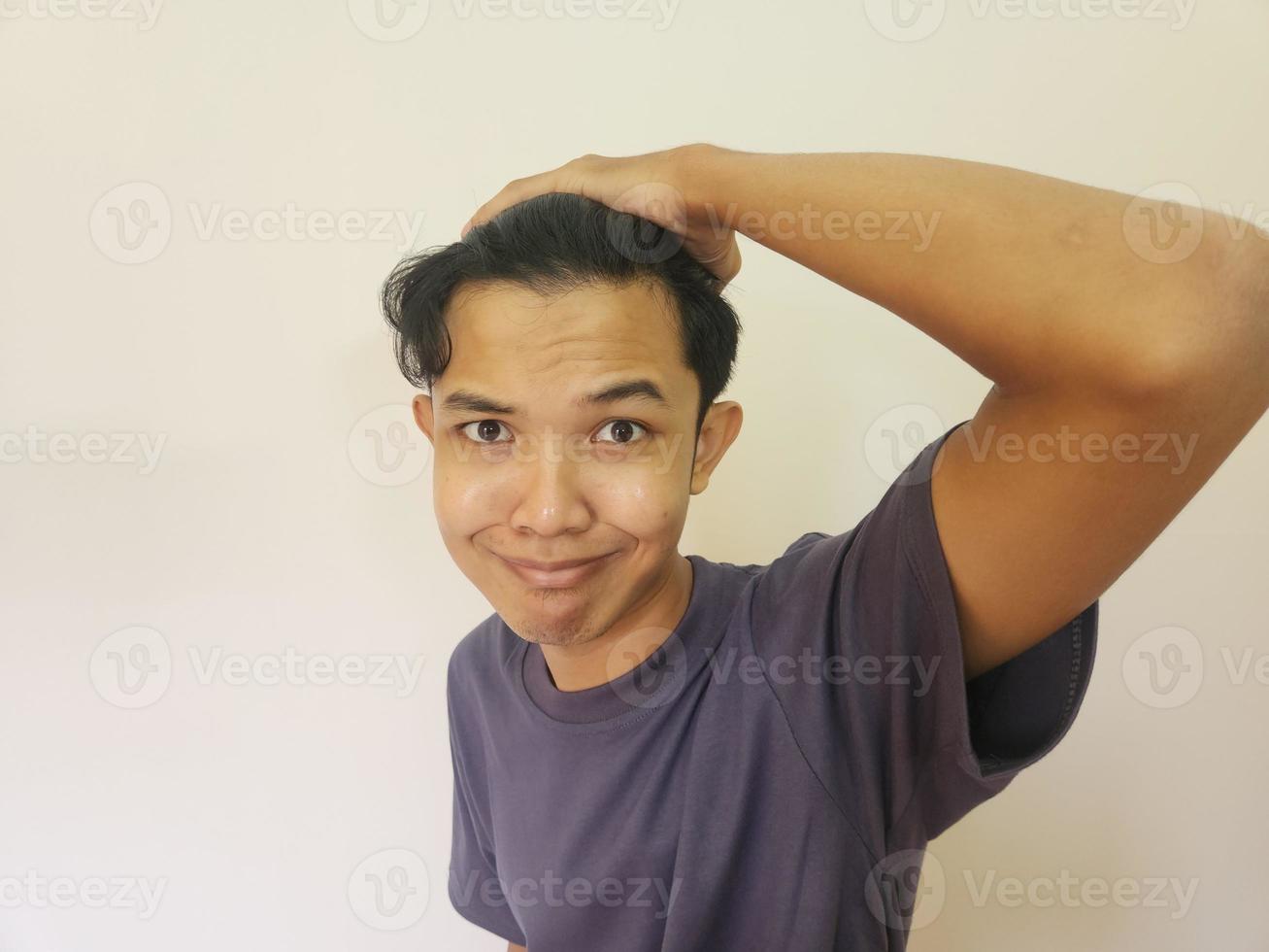 Shocked face of Asian man getting bald and lost hair in isolated white background photo