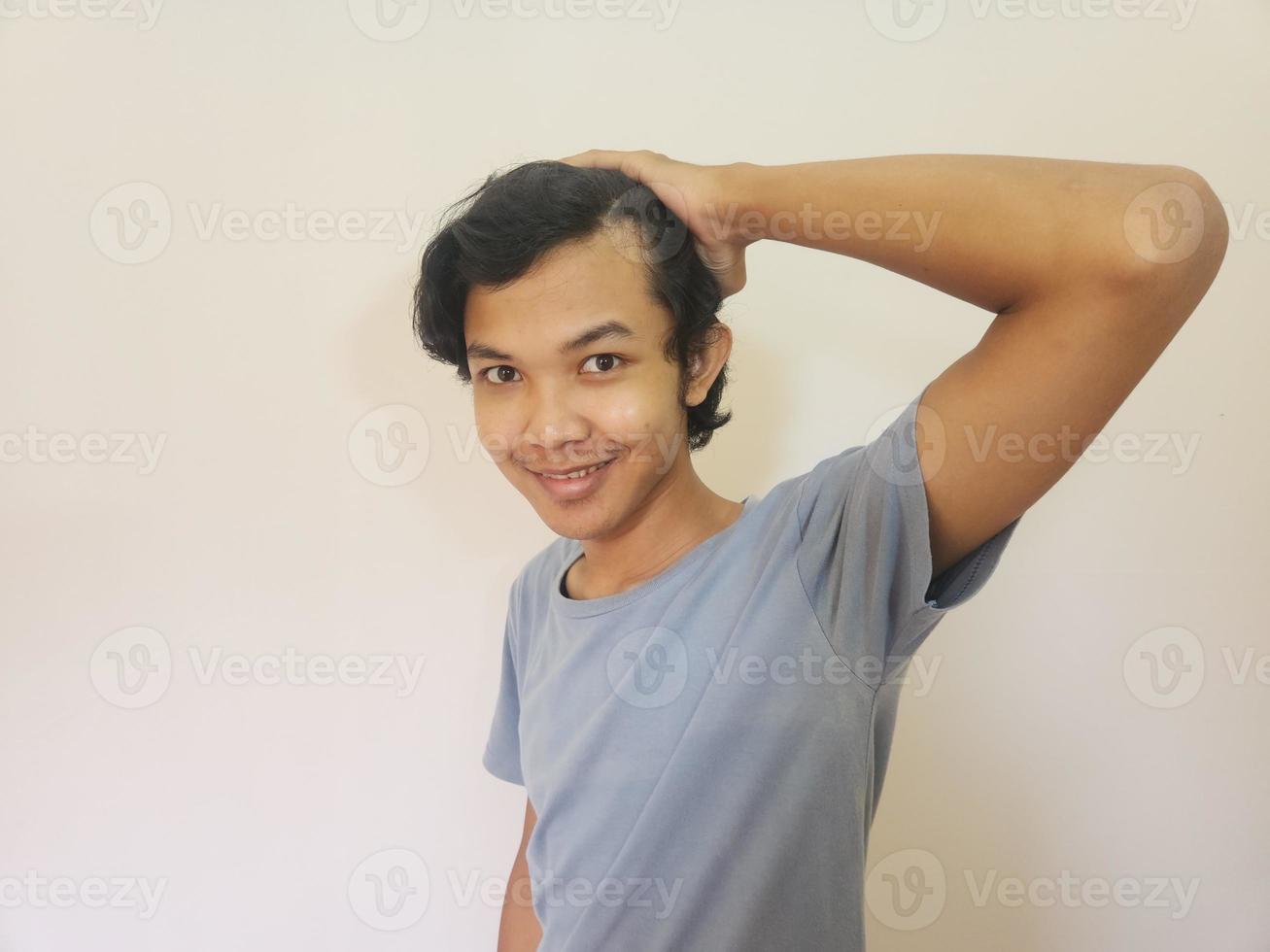 Shocked face of Asian man getting bald and lost hair in isolated white background photo