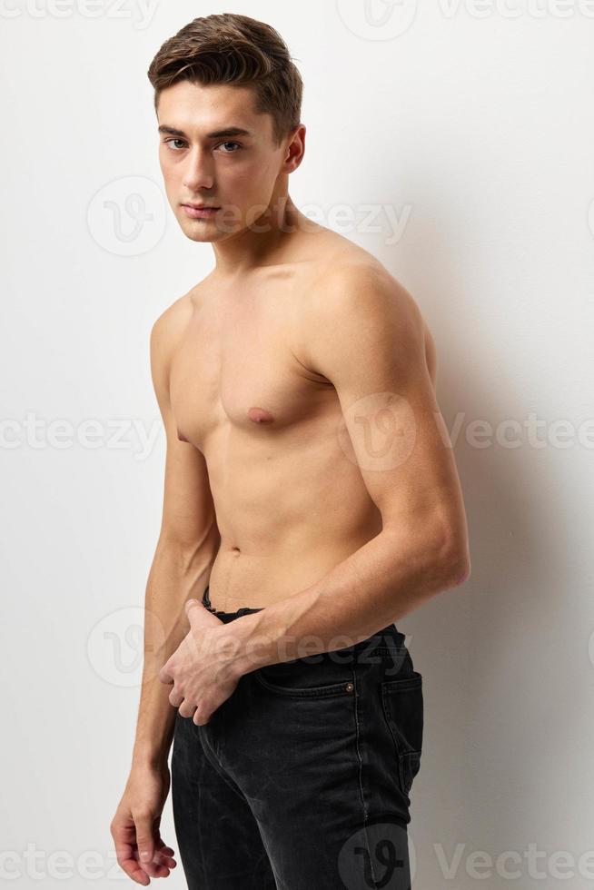 handsome man fashion hairstyle nude torso cropped view studio posing photo